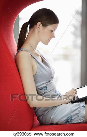 Stock Photography - Businesswoman using digital tablet in an office. Fotosearch