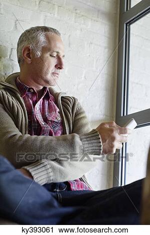 Man text messaging on a mobile phone View Large Photo Image Stock Image - Man text messaging on a mobile phone. Fotosearch