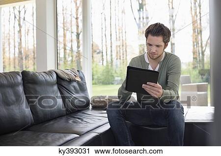 Stock Image - Man using a digital tablet. Fotosearch