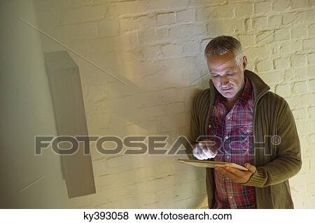Man using a digital tablet View Large Photo Image Stock Photo - Man using a digital tablet. Fotosearch