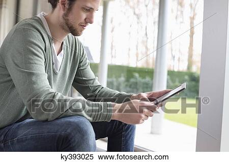 Man using a digital tablet View Large Photo Image Stock Photography - Man using a digital tablet. Fotosearch