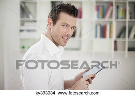 Man using an electronic book View Large Photo Image Picture - Man using an electronic book. Fotosearch