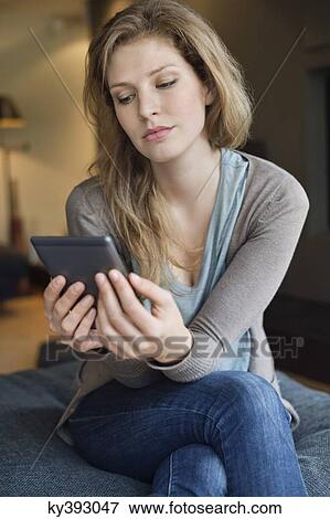 Woman using digital tablet View Large Photo Image Stock Photo - Woman using digital tablet. Fotosearch