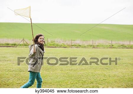 Boy holding a butterfly net in a field View Large Photo Image Stock Photography - Boy holding a butterfly net in a field. Fotosearch