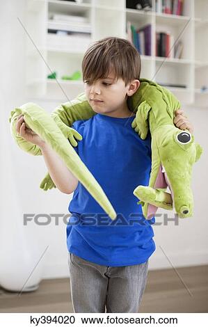 Boy playing with animals toys View Large Photo Image Stock Image - Boy playing with animals toys. Fotosearch