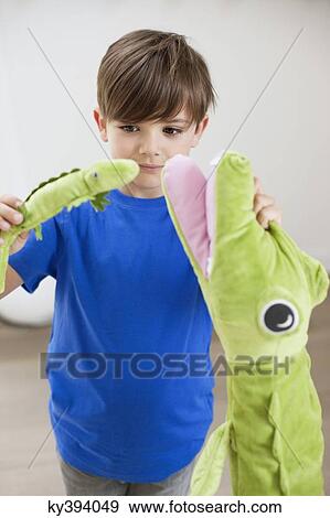 Boy playing with animals toys View Large Photo Image Stock Photo - Boy playing with animals toys. Fotosearch
