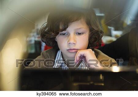 Boy using a laptop View Large Photo Image Stock Photography - Boy using a laptop. Fotosearch