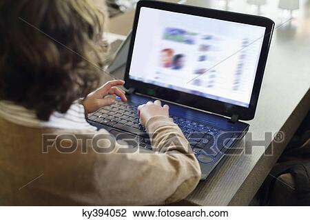 Boy using laptop View Large Photo Image Stock Image - Boy using laptop. Fotosearch