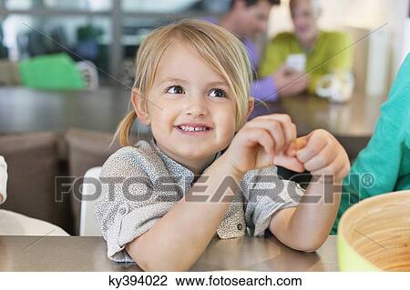 Stock Image - Close-up of a cute girl smiling. Fotosearch