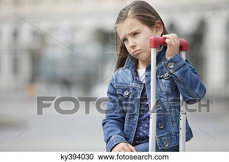 Close-up of a girl with her luggage View Large Photo Image Stock Image - Close-up of a girl with her luggage. Fotosearch