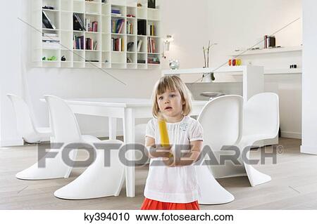 Stock Image - Girl holding a large pencil. Fotosearch