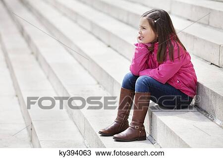 Girl sitting on the steps and smiling View Large Photo Image Stock Image - Girl sitting on the steps and smiling. Fotosearch