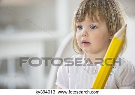 Girl with a big pencil View Large Photo Image Stock Image - Girl with a big pencil. Fotosearch