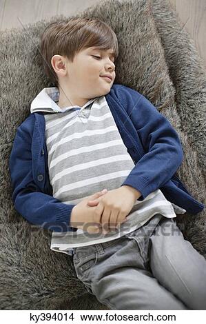 High angle view of a boy sleeping View Large Photo Image Picture - High angle view of a boy sleeping. Fotosearch