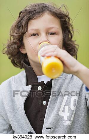 Stock Photo - Portrait of a boy drinking juice. Fotosearch