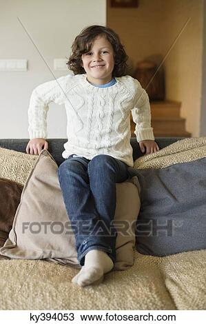 Stock Image - Portrait of a boy smiling at home. Fotosearch