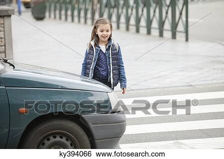 Schoolgirl crossing a road View Large Photo Image Stock Photograph - Schoolgirl crossing a road. Fotosearch