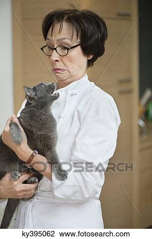 Stock Image - Cat snarling on a woman. Fotosearch