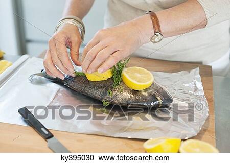 Elderly woman preparing seafood in a kitchen View Large Photo Image Stock Image - Elderly woman preparing seafood in a kitchen. Fotosearch