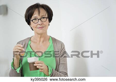 Stock Photograph - Portrait of a woman drinking tea. Fotosearch