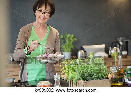 Portrait of a woman tasting food View Large Photo Image Stock Image - Portrait of a woman tasting food. Fotosearch