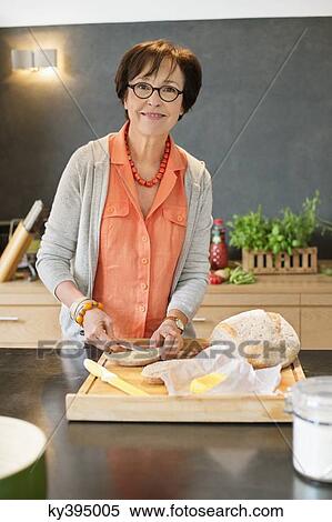 Woman applying butter on bread View Large Photo Image Stock Photography - Woman applying butter on bread. Fotosearch