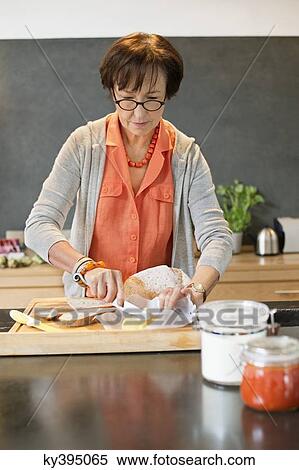 Woman applying butter on bread View Large Photo Image Stock Photography - Woman applying butter on bread. Fotosearch