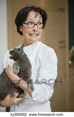 Stock Image - Woman holding a cat. Fotosearch
