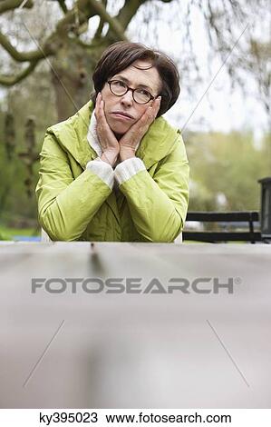 Stock Image - Woman lost in thoughts. Fotosearch