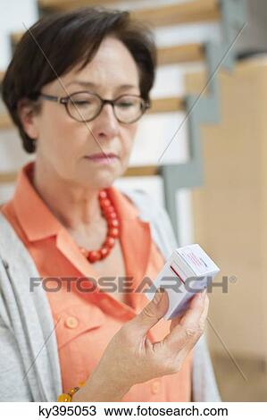 Woman reading a prescription View Large Photo Image Stock Image - Woman reading a prescription. Fotosearch