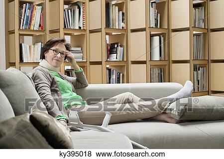 Woman resting on a couch View Large Photo Image Stock Photo - Woman resting on a couch. Fotosearch