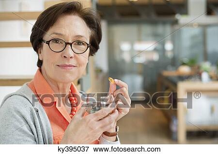 Stock Photo - Woman taking medicine. Fotosearch