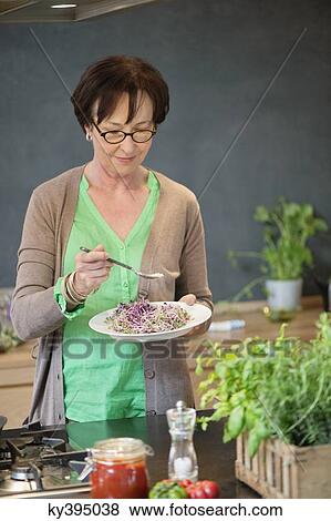 Stock Photo - Woman tasting food. Fotosearch