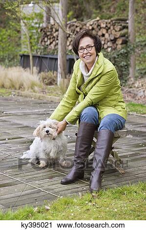 Stock Image - Woman with her dog. Fotosearch