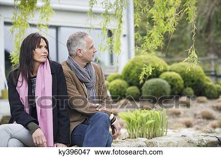 Stock Photo - Couple sitting in a garden. Fotosearch