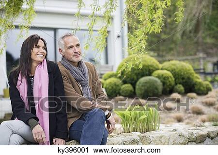 Romantic couple sitting in a garden View Large Photo Image Stock Image - Romantic couple sitting in a garden. Fotosearch
