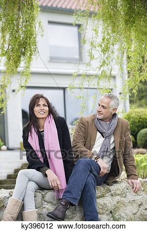Romantic couple sitting in a garden View Large Photo Image Stock Image - Romantic couple sitting in a garden. Fotosearch