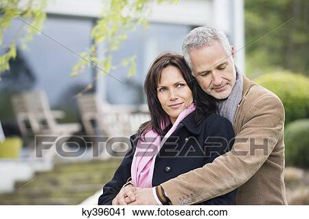 Stock Image - Romantic couple sitting in a garden. Fotosearch