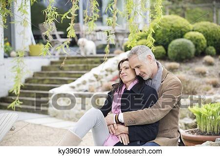 Romantic couple sitting in a garden View Large Photo Image Stock Photo - Romantic couple sitting in a garden. Fotosearch
