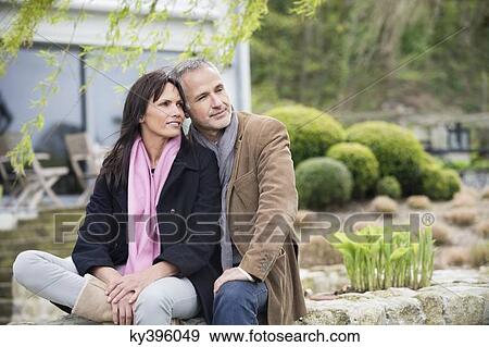 Romantic couple sitting in a garden View Large Photo Image Stock Photo - Romantic couple sitting in a garden. Fotosearch