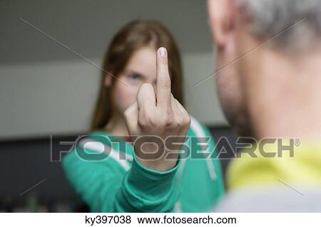 Girl showing middle finger to her father View Large Photo Image Stock Photo - Girl showing middle finger to her father. Fotosearch