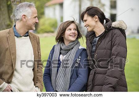 Stock Image - Happy family in a lawn. Fotosearch