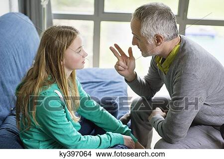Man discussing with his daughter at home View Large Photo Image Picture - Man discussing with his daughter at home. Fotosearch
