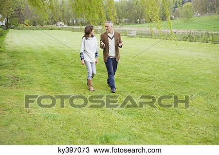 Man discussing with his daughter during walk in a park View Large Photo Image Stock Image - Man discussing with his daughter during walk in a park. Fotosearch