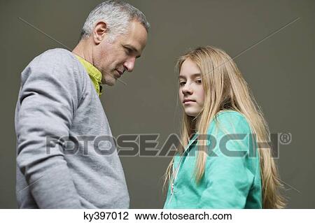 Man frowning on his daughter looking sad View Large Photo Image Stock Image - Man frowning on his daughter looking sad. Fotosearch