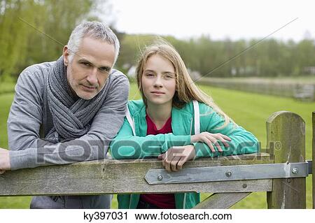 Stock Image - Man with his daughter in a farm. Fotosearch