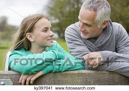 Man with his daughter in a farm View Large Photo Image Stock Image - Man with his daughter in a farm. Fotosearch