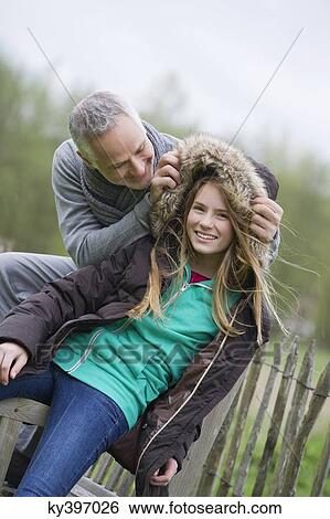 Man with his daughter in a farm View Large Photo Image Stock Photograph - Man with his daughter in a farm. Fotosearch