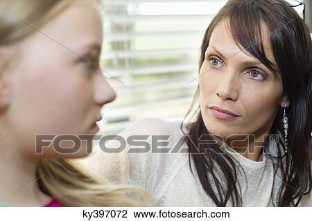 Stock Image - Woman and daughter frowning to each other. Fotosearch