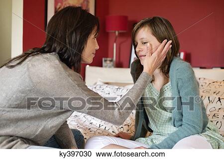 Woman consoling her sad daughter in the bedroom View Large Photo Image Stock Image - Woman consoling her sad daughter in the bedroom. Fotosearch